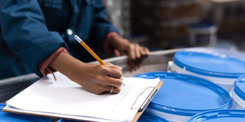woman-worker-taking-notes-warehouse